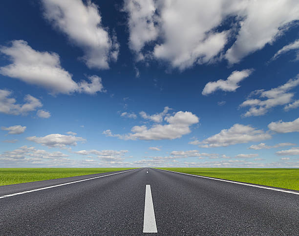istock Road under beautiful sky between green hills 481569804