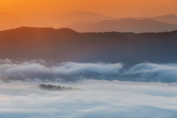 istock Carpathian Mountains. Mountains covered in mist at sunrise 481571402