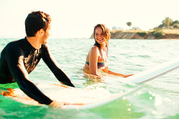 istock Couple of surfers in action 481571834