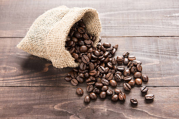 istock coffee beans in a bag on wooden background 481571944