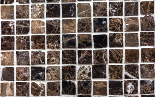 A display pattern of square tiles with varying colors and textures.