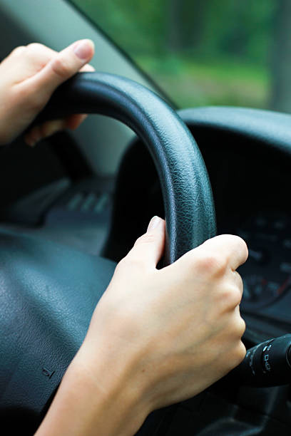 istock Female hands on a car wheel 481572179