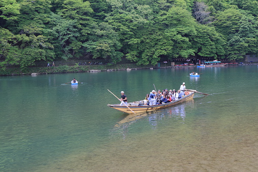 Kyoto Japan - May 6, 2015: People take Hozu river cruise boat in Arashiyama Kyoto Japan.