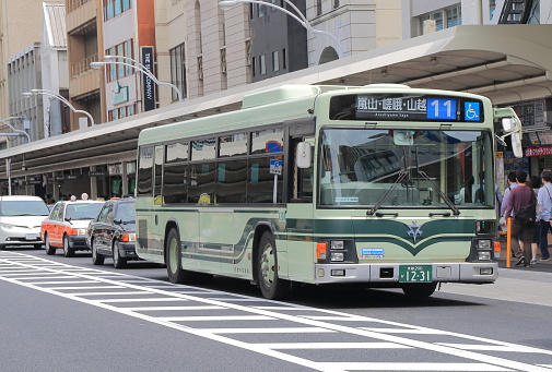 Kyoto Japan - May 6, 2015: Kyoto City bus runs in busy Shijyo street in Kyoto Japan.