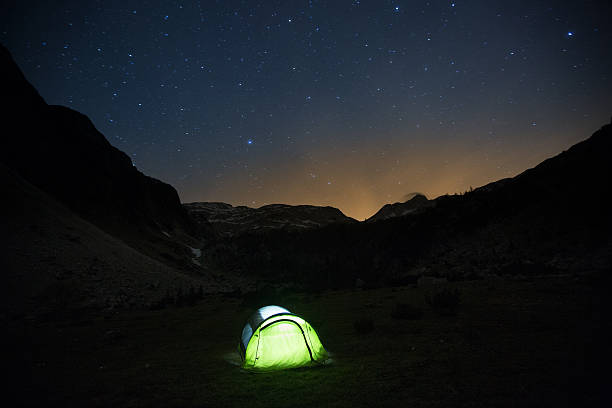 istock Tent standing on a mountain pasture under starry sky 481572942