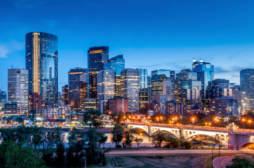 A high angle view over the city of LA, California, with the towers of Downtown illuminated during the blue hour following sunset.