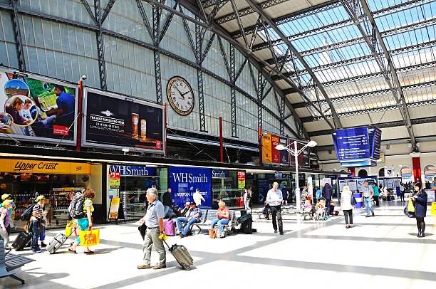 Trains wait at the platform beyond the no entry barriers at a deserted Brighton train station in East Sussex, UK.