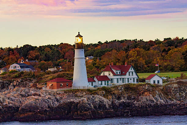 Portland Head Lighthouse Portland Head Light as seen in the early morning from a passing cruise ship.  The lighthouse is located in Cape Elizabeth, Maine. casco bay stock pictures, royalty-free photos & images