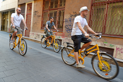 Budapest, Hungary - July 12, 2015. People riding rented bicycles at the streets of Budapest, Hungary. There are also many designated cycling paths inside the city.