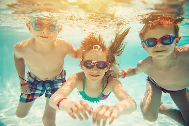 Photo of Kids swimming underwater