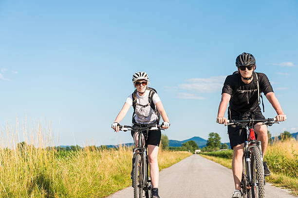 istock Young man and woman biking in nature 481581082