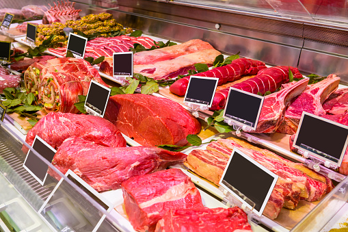 Photo of meats on a refrigeretor at a supermarket. Butcher shop. Butchery.