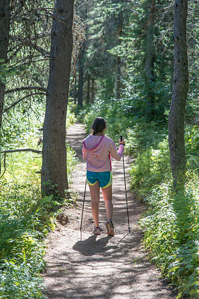 istock Hiking girl walking in forest track 481599372