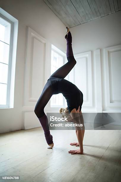 Flexible Gymnast Doing Exercise Stock Photo - Download Image Now - 2015, Active Lifestyle, Activity