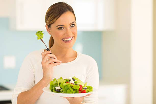 istock woman eating vegetable salad 481604810
