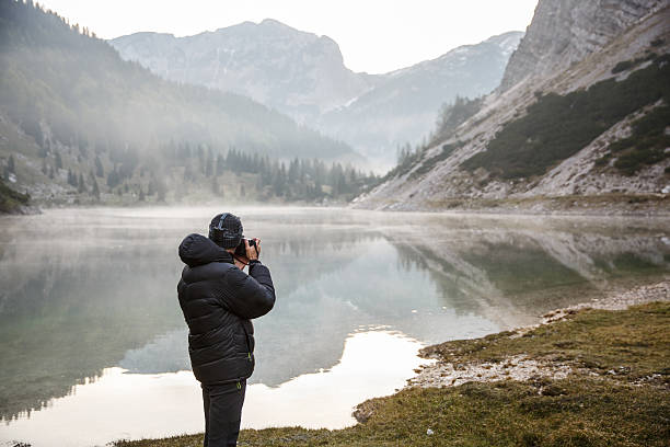 istock Photographer holding a camera, taking photos 481605436