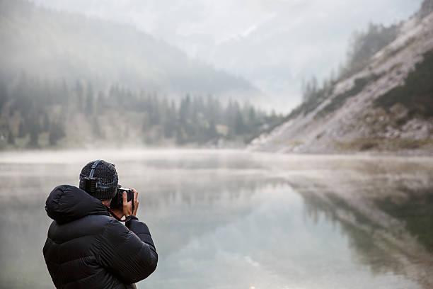istock Photographer holding a camera, taking photos 481605468
