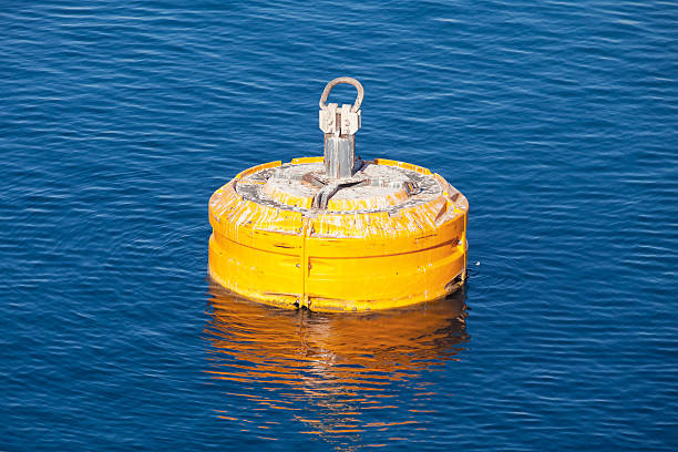 istock Yellow mooring buoy floating on blue water 481607856