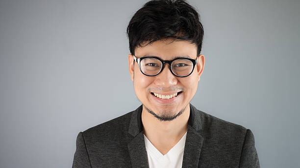 istock Asian businessman in black suit with grey background. 481608044