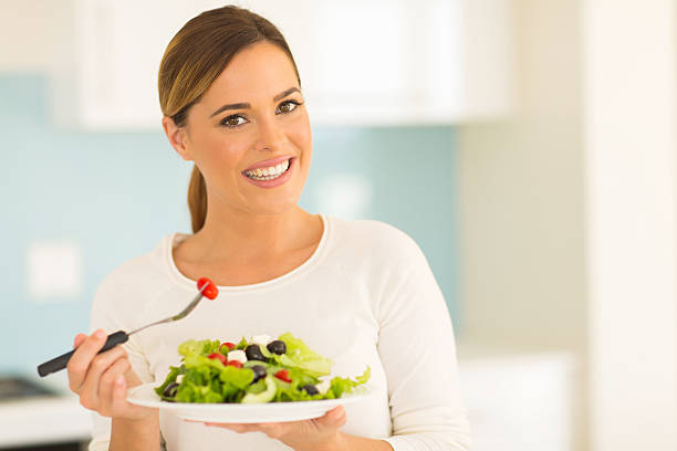 istock vegetarian eating salad at home 481610208