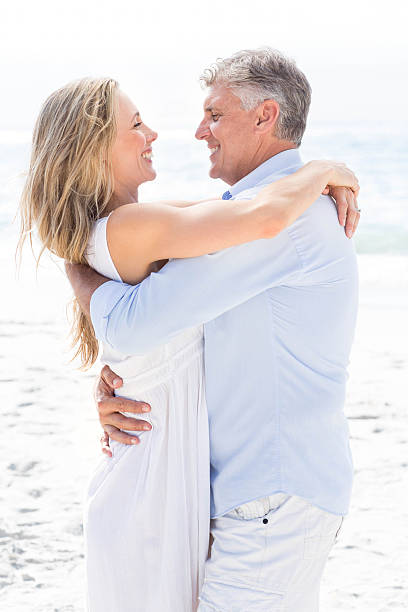 istock Happy couple hugging each other by the sea 481610480