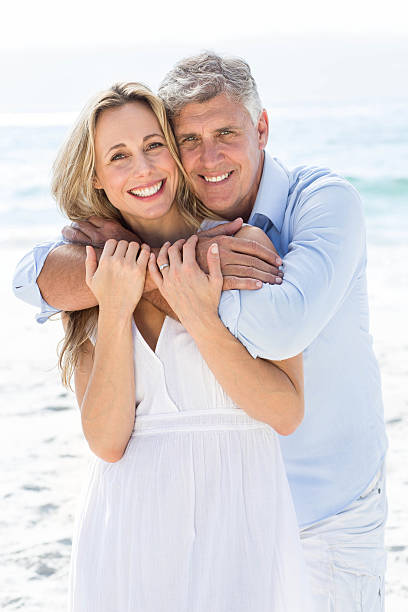 istock Happy couple hugging each other by the sea 481610504