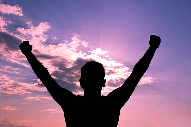 istock Cheering young man raising his arms against sky 481610644