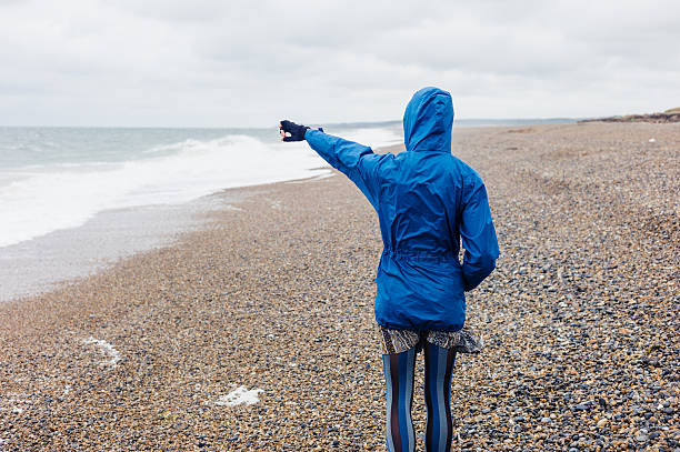istock Young woman walking on the beach 481611240