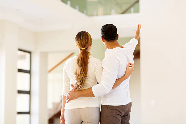istock couple looking around their new home 481613726