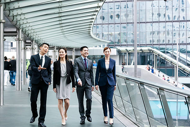 istock Four business people walking on bridge 481614218