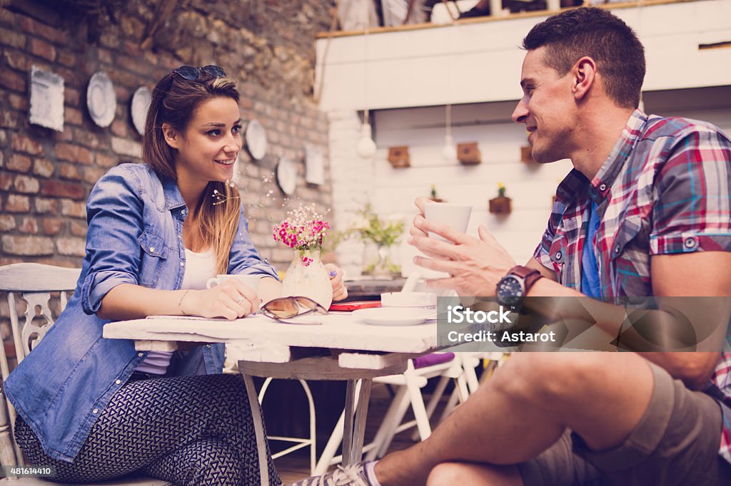 Young happy couple sitting at cafe 2015 Stock Photo