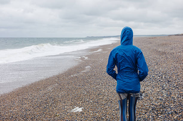 istock Young woman walking on the beach 481614658