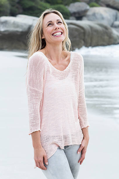 istock Smiling blonde standing by the sea 481615346