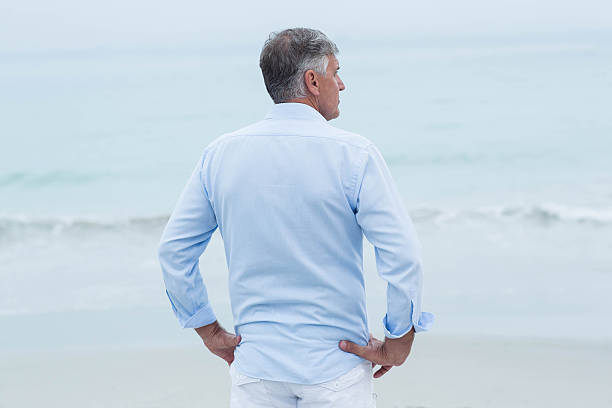 istock Thoughtful man standing by the sea 481615392
