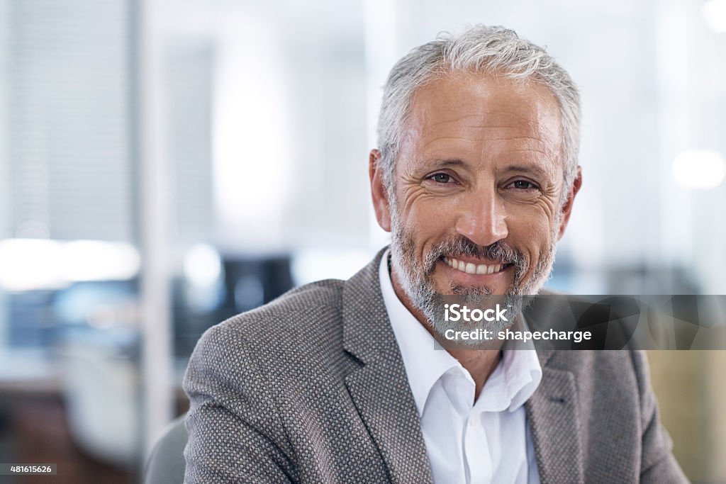 The smile of success Cropped portrait of a mature businessman sitting in his officehttp://195.154.178.81/DATA/i_collage/pu/shoots/805334.jpg Portrait Stock Photo