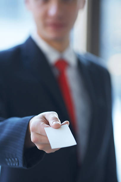 istock businessman giving a business card 481615944