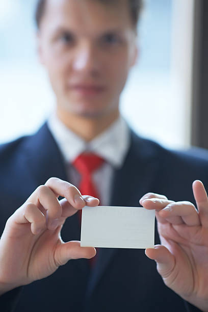 istock businessman giving a business card 481615956