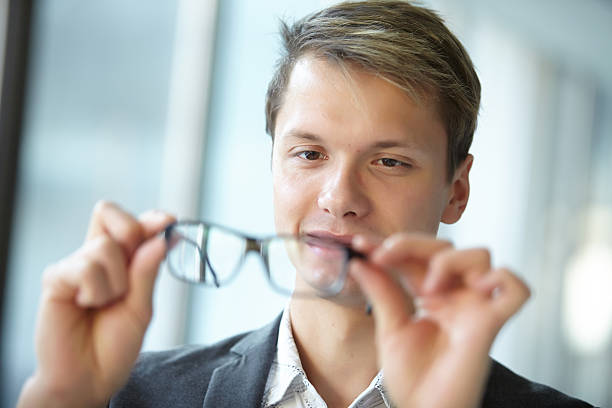 istock young businessman with glasses standing in the hallway 481618408