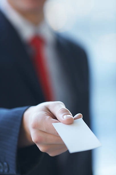istock businessman giving a business card 481618648