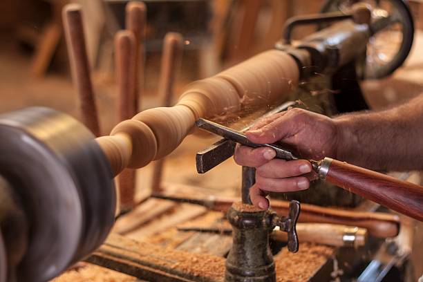 turning wood worker turning wood on a lathe lathe stock pictures, royalty-free photos & images