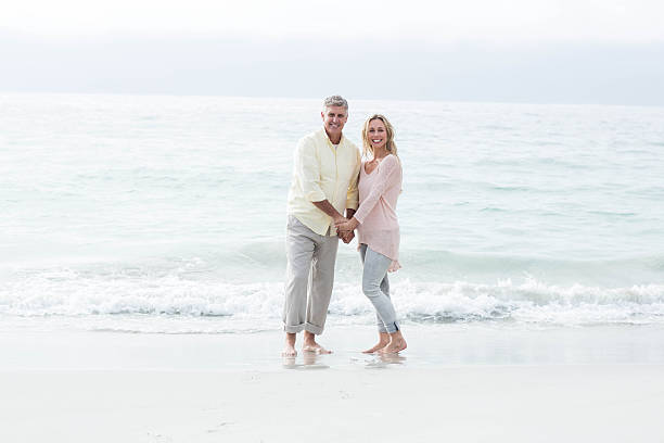 istock Happy couple standing by the sea 481619784