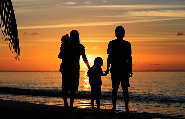 istock happy family with two kids on sunset beach 481622586