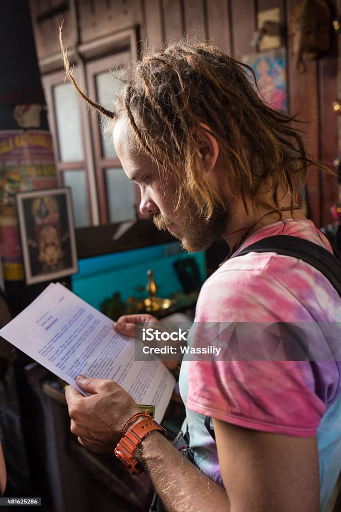 Serious male student reading Serious male student reading a book in a library 2015 Stock Photo