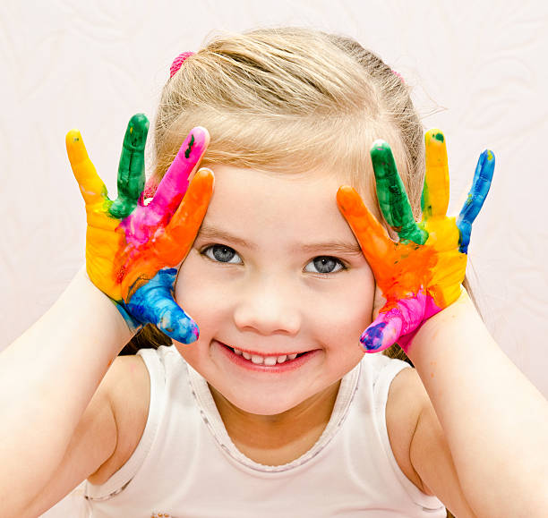 istock Cute smiling little girl with hands in paint 481625699