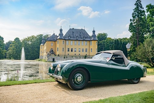 Jüchen, Germany - August 1, 2014: Jaguar XK120 classic sports car in front of Schloss Dyck. The car is on display during the 2014 Classic Days event at Schloss Dyck.
