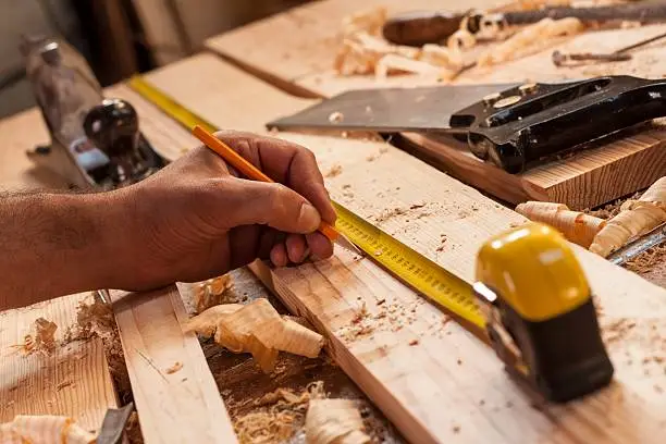 Photo of carpenter taking measurement