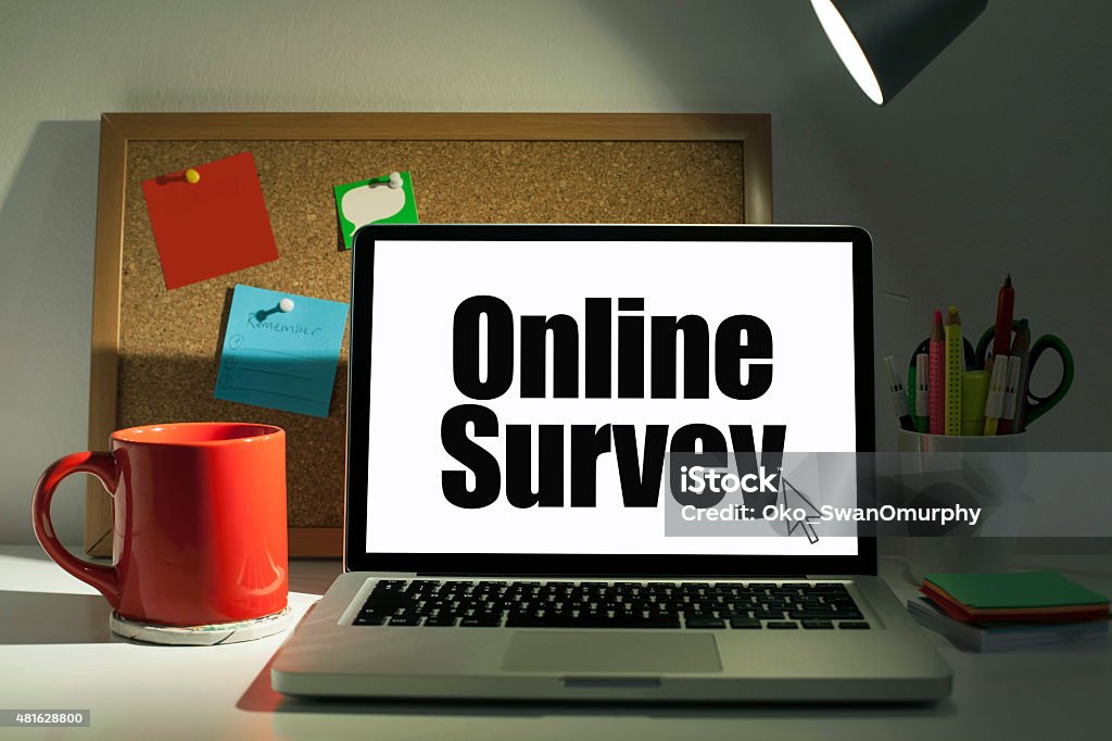 Online Survey Online survey concept with laptop computer on desk in office interior Internet Stock Photo