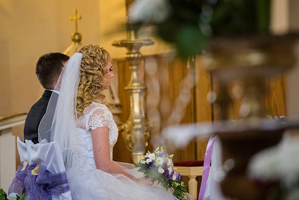 istock Bride and groom sitting in front of altar 481628954