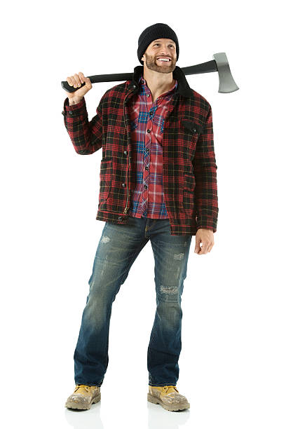 Smiling lumberjack standing with axe on shoulder