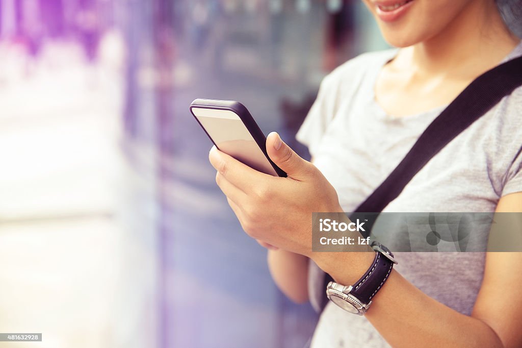 young asian woman use smartphone at city 2015 Stock Photo